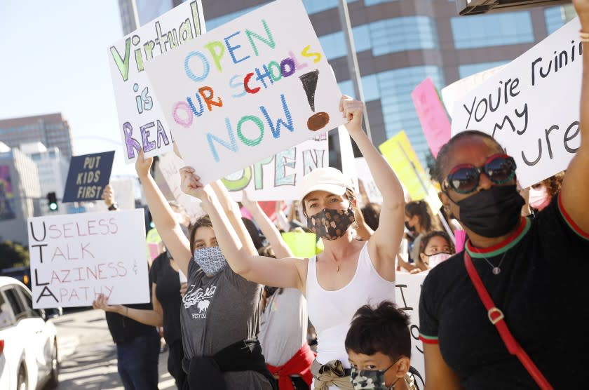 LOS ANGELES-CA-FEBRUARY 22, 2021: Parents demonstrate and withhold kids from online classes to pressure the L.A. Unified School District to bring students back for in-person instruction and other services outside the West L.A. Federal Building on Monday, February 22, 2021. (Christina House / Los Angeles Times)