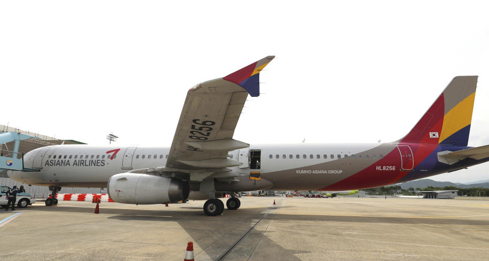 An Asiana Airlines plane is parked as one of the plane's doors suddenly opened at Daegu International Airport in Daegu, South Korea, Friday, May 26, 2023. A passenger opened a door on an Asiana Airlines flight that later landed safely at a South Korean airport Friday, airline and government officials said. (Yun Kwan-shick/Yonhap via AP)