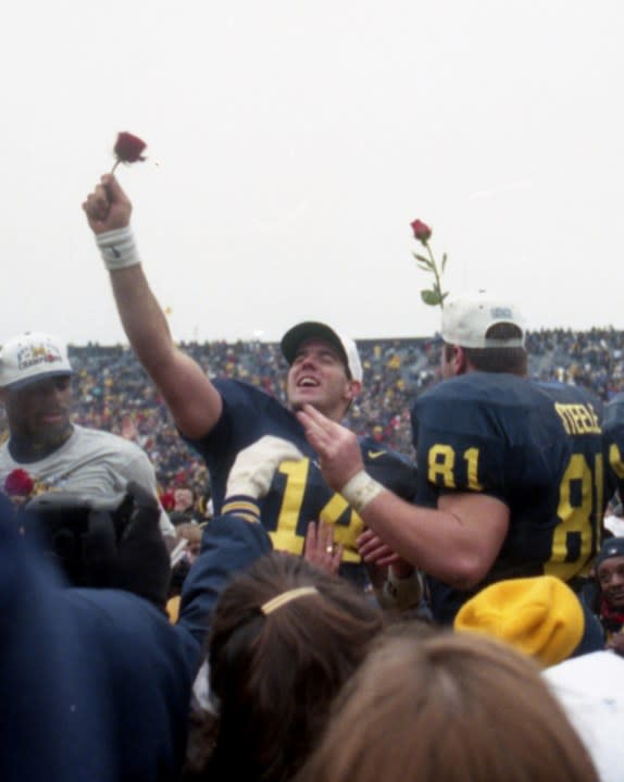 Brian Griese and Glen Steele show off their roses to the fans at Michigan Stadium.