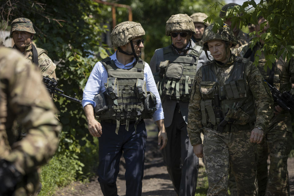 Ukrainian President Volodymyr Zelenskiy talks with servicemen as he visits the war-hit Luhansk region, eastern Ukraine, Monday, May 27, 2019. (Ukrainian Presidential Press Office via AP)