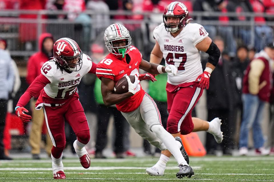 Nov 12, 2022; Columbus, Ohio, USA;  Ohio State Buckeyes wide receiver Marvin Harrison Jr. (18) runs oast Indiana Hoosiers defensive back Lem Watley-Neely (12) during the second half of the NCAA football game at Ohio Stadium. Ohio State won 56-14. Mandatory Credit: Adam Cairns-The Columbus Dispatch