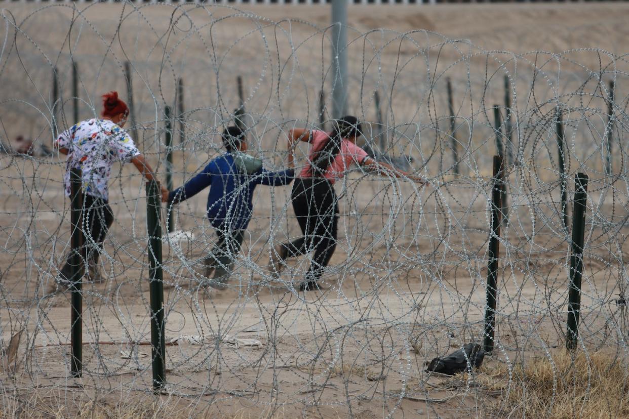 Migrants cross the border from Mexico into Texas on Feb. 6, 2024. <a href="https://www.gettyimages.com/detail/news-photo/migrants-cross-the-border-to-usa-through-gate-36-and-to-be-news-photo/1983631787?adppopup=true" rel="nofollow noopener" target="_blank" data-ylk="slk:Christian Torres/Anadolu via Getty Images;elm:context_link;itc:0;sec:content-canvas" class="link ">Christian Torres/Anadolu via Getty Images</a>