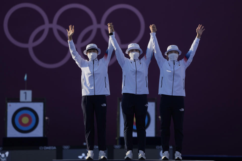 From left first placed South Korea's An San, Jang Minhee, and Kang Chaeyoung celebrate on the podium during the medal ceremony of the women's team competition at the 2020 Summer Olympics, Sunday, July 25, 2021, in Tokyo, Japan. (AP Photo/Alessandra Tarantino)