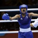 Great Britain's Natasha Jonas, reacts after her fight against the United States' Quanitta Underwood during a women's lightweight boxing match at the 2012 Summer Olympics, Sunday, Aug. 5, 2012, in London. (AP Photo/Patrick Semansky)