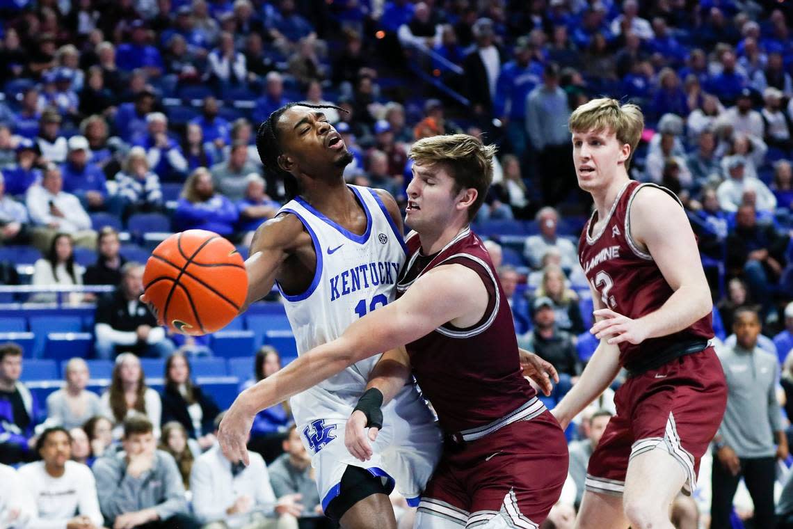 Kentucky guard Antonio Reeves (12) collides with a Bellarmine Knights player during Tuesday’s game at Rupp Arena.