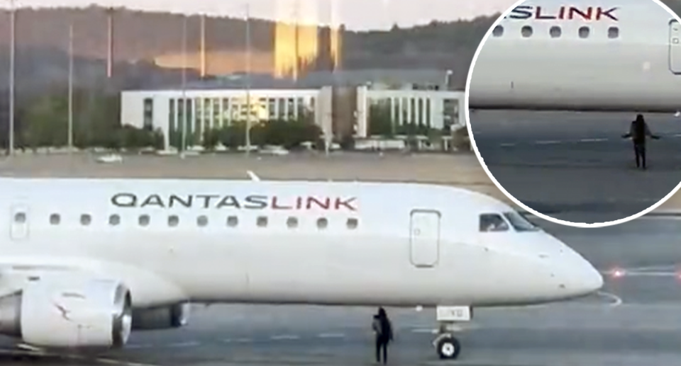 The woman is seen dangerously close to the Qantas Link flight. 