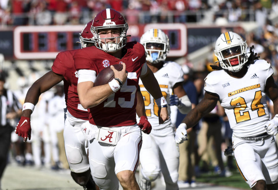 Nov 18, 2023; Tuscaloosa, Alabama, USA; Alabama Crimson Tide quarterback Ty Simpson (15) outruns Chattanooga Mocs defensive back Josh Battle (24) on his way to an apparent touchdown at Bryant-Denny Stadium. On replay, Simpson was ruled to have dropped the ball on the one yard line where Alabama had a first and goal. Alabama won 66-10. Mandatory Credit: Gary Cosby Jr.-USA TODAY Sports