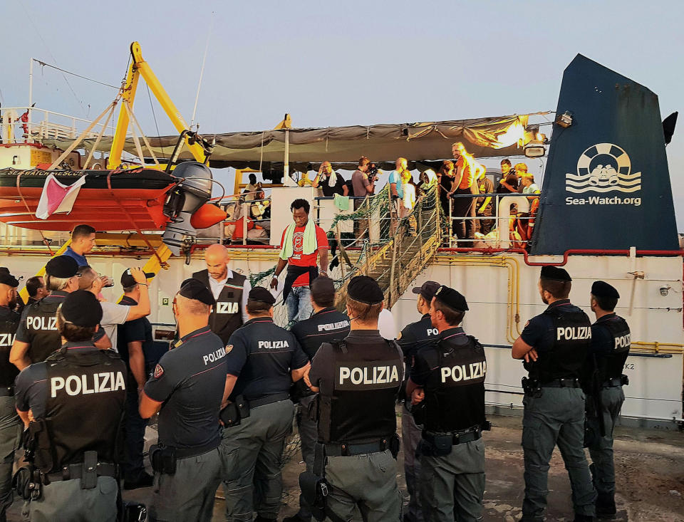 Migrants disembark from the Ducth-flagged Sea-Watch 3 ship, at Lampedusa island's harbor, Italy, Saturday, June 29, 2019. Forty migrants have disembarked on a tiny Italian island after the captain of the German aid ship which rescued them docked without permission. Sea-Watch 3 rammed an Italian border police motorboat as it steered toward the pier on Lampedusa. (Elio Desiderio/ANSA via AP)