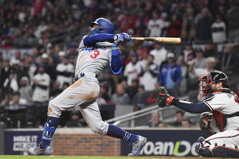 Dodgers' Chris Taylor follows through on a swing for a go-ahead two-run double.