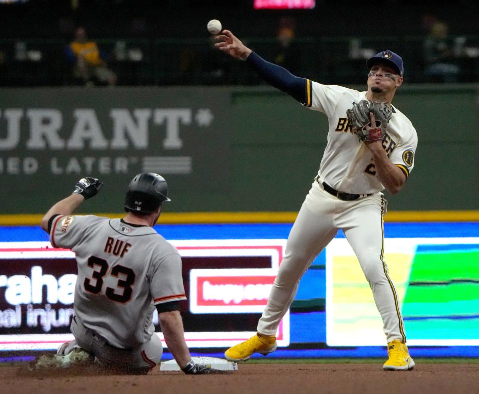 San Francisco Giants left fielder Darin Ruf (33) is out at second as Milwaukee Brewers shortstop Willy Adames (27) turns a double play during the fourth Inning of their game Monday, April 25, 2022 at American Family Field in Milwaukee, Wis.