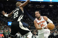 New York Knicks' Jalen Brunson (11) drives to the basket against Milwaukee Bucks' Khris Middleton (22) during the first half of an NBA basketball game Sunday, April 7, 2024, in Milwaukee. (AP Photo/Aaron Gash)