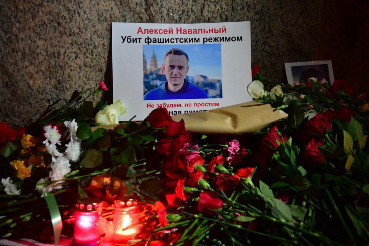 A memorial to Russian opposition leader Alexei Navalny laid in Saint Petersburg on February 16, 2024. <a href="https://www.gettyimages.com/detail/news-photo/flowers-lay-next-to-a-picture-of-late-russian-opposition-news-photo/2008317893?adppopup=true" rel="nofollow noopener" target="_blank" data-ylk="slk:Olga Maltseva/AFP via Getty Images;elm:context_link;itc:0;sec:content-canvas" class="link ">Olga Maltseva/AFP via Getty Images</a>