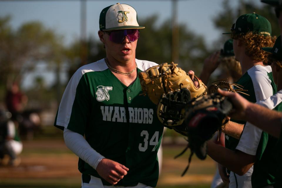 Jupiter infielder Brady Blanks (34) claps hands with teammates prior to the start of the District 11-7A championship baseball game between host Jupiter and Palm Beach Central on Thursday, May 4, 2023, in Jupiter, Fla. Final score, Jupiter, 11, Palm Beach Central, 3.