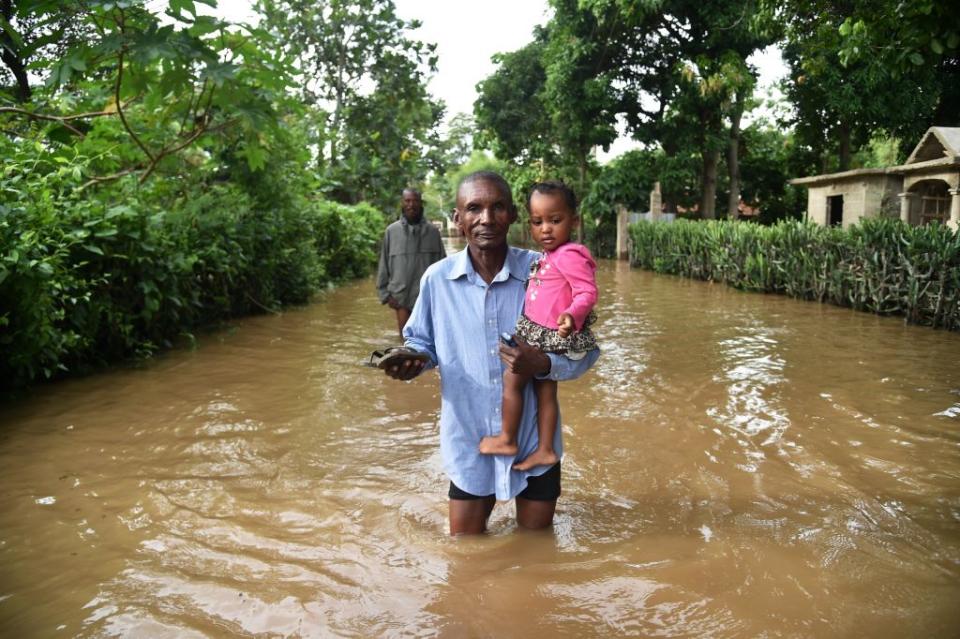 A man walks in street that was flooded in Malfeti, in the city of Fort Liberte, in the city of Fort Liverte, in the north east of Haiti, on Sept. 8, 2017, during the passage of Hurricane Irma. | AFP Contributor—AFP/Getty Images