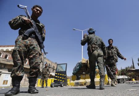 Police troopers secure the entrance of the U.S. embassy in Sanaa February 11, 2015. The United States is closing its embassy in Yemen, the Arabian peninsula state that is a front line in Washington's war against al Qaeda, embassy employees and U.S. officials said on Tuesday. REUTERS/Khaled Abdullah