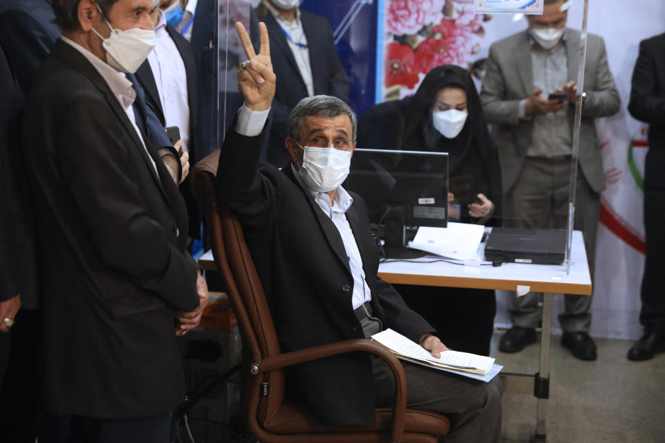 Former President Mahmoud Ahmadinejad flashes a victory sign while registering his name as a candidate for the June 18 presidential elections at the elections headquarters of the Interior Ministry in Tehran, Iran, Wednesday, May 12, 2021. The country's former firebrand president will run again for office in upcoming elections in June. The Holocaust-denying Ahmadinejad has previously been banned from running for the presidency by Supreme Leader Ayatollah Ali Khamenei in 2017, although then, he registered anyway. (AP Photo/Vahid Salemi)