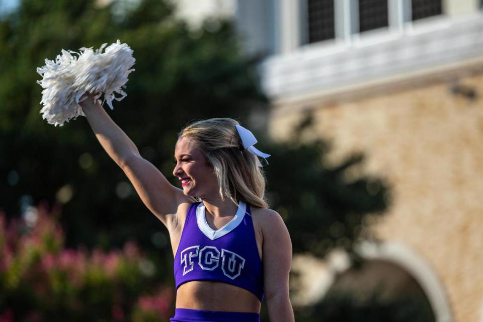 A TCU cheerleader fires up the crowd during the Fox Big Noon Kickoff show prior to the TCU football game against the Colorado Buffaloes at Amon G. Carter Stadium in Fort Worth on Saturday, Sept. 2, 2023.