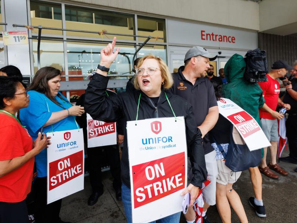  Lana Payne, the Unifor National president, shouts alongside workers at a picket line outside a Metro grocery store in Toronto on July 29.