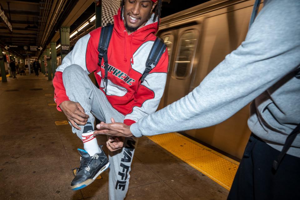 Doc Jr. shows how he doubles up his socks to swing upside down on the subway