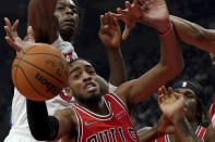 Chicago Bulls forward Troy Brown Jr., bottom left, and Toronto Raptors forward OG Anunoby, top left, vie for control of the ball during first-half NBA basketball game action in Toronto, Monday, Oct. 25, 2021. (Nathan Denette/The Canadian Press via AP)