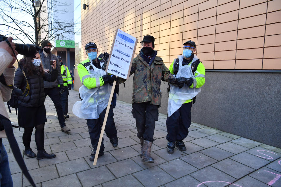 Police lead a protester away at Bristol Magistrates' Court. (PA)