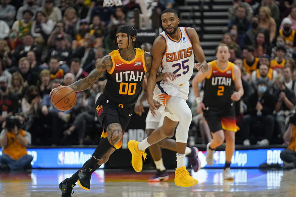 Phoenix Suns forward Mikal Bridges (25) defends against Utah Jazz guard Jordan Clarkson (00) in the first half during an NBA basketball game Wednesday, Jan. 26, 2022, in Salt Lake City. (AP Photo/Rick Bowmer)