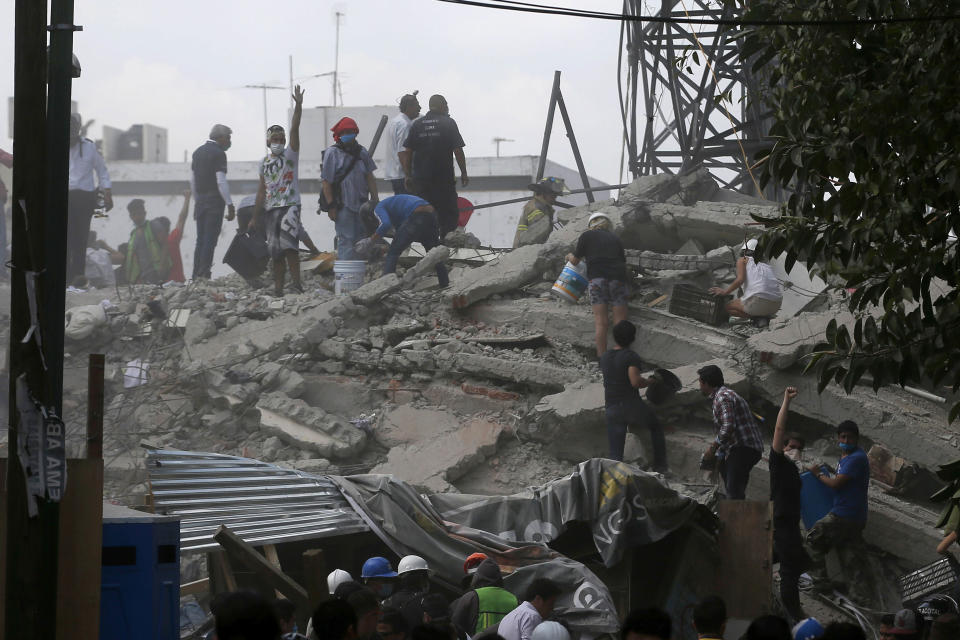 <p>Volunteers search a building that collapsed after an earthquake, in the Roma neighborhood of Mexico City, Tuesday, Sept. 19, 2017. A magnitude 7.1 earthquake has rocked central Mexico, killing at least 55 people as buildings collapsed in plumes of dust and thousands fled into the streets in panic. (AP Photo/Eduardo Verdugo) </p>