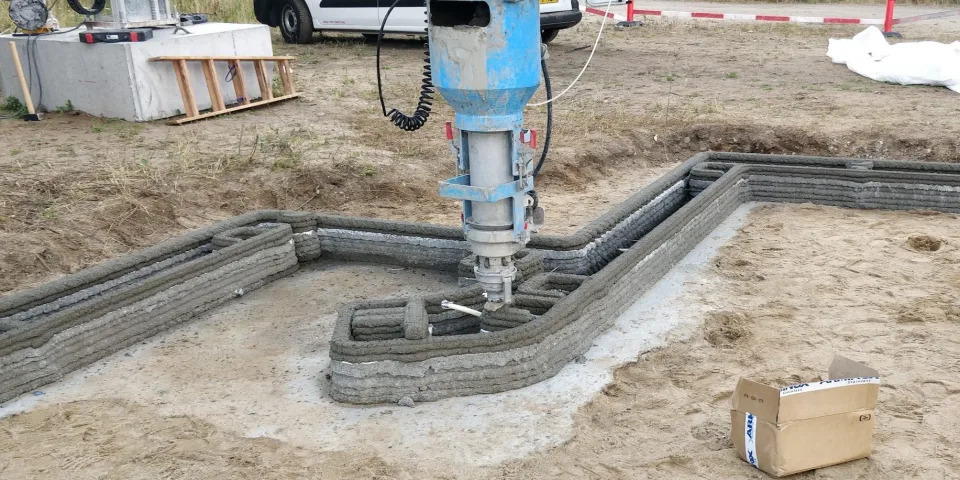 The COBOD printer printing the walls of the 3D printed home.