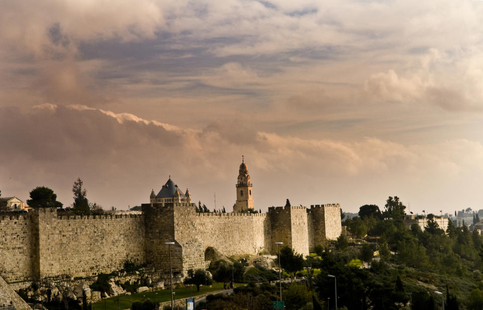 The old city wall and Mt. Zion during sunset.