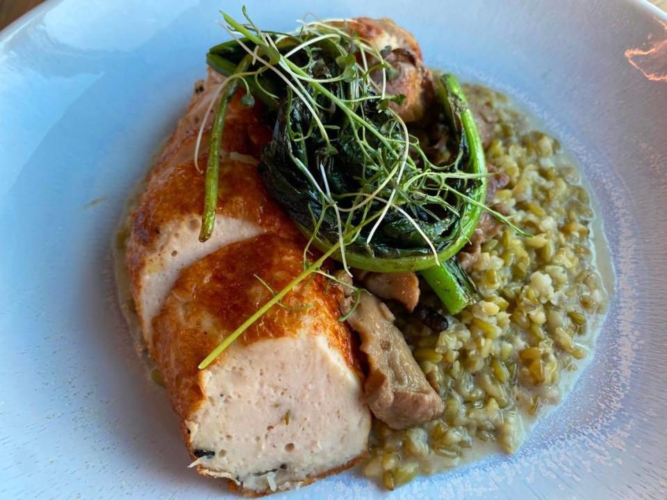 Lotte’s Black Truffled Chicken is served with buttery mushrooms atop a serving of farro porridge.