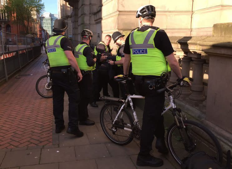 The man is detained by police (PA)