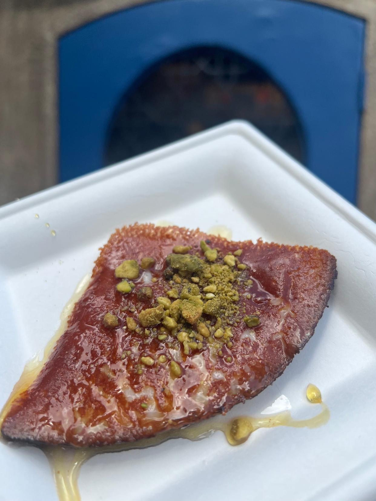 Griddled Cheese is topped with pistachios and honey at EPCOT's Greece kiosk. The cheese is nutty even without the pistachios and the honey is not overly sweet.