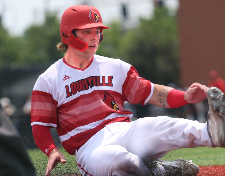 Louisville’s Dalton Rushing slides into third safely against Virginia in the last game of the regular season.May 21, 2022