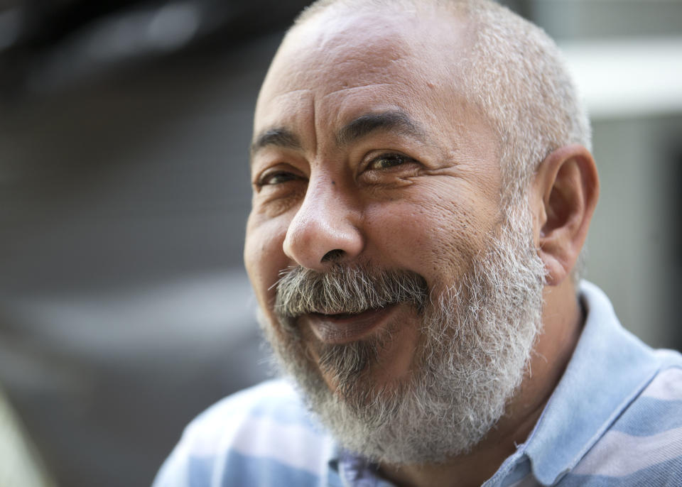 Cuban author Leonardo Padura laughs during an interview in Coral Gables, Fla., Wednesday, Feb. 19, 2014. Padura is the most internationally well-known living author on the island - one who has managed to carve a space in which he can cast a critical eye while being neither a member of the community party, nor a dissident. Now, at the height of his literary career, he is on a tour in the United States, visiting Miami, New York and Chicago. His critically acclaimed "The Man Who Loved Dogs" has been translated into English and published in the U.S. by Farrar, Straus and Giroux. (AP Photo/Wilfredo Lee)