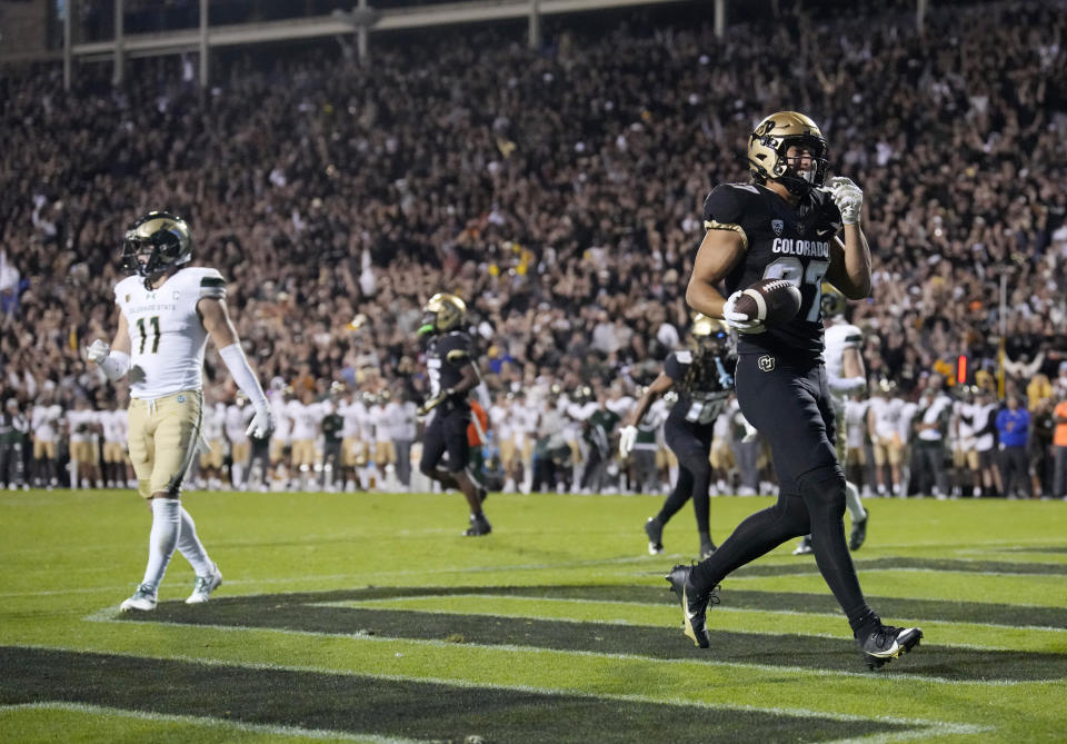 Colorado tight end Michael Harrison, right, reacts after catching a pass for a touchdown in the second overtime of an NCAA college football game as Colorado State defensive back Henry Blackburn looks on Saturday, Sept. 16, 2023, in Boulder, Colo. (AP Photo/David Zalubowski)