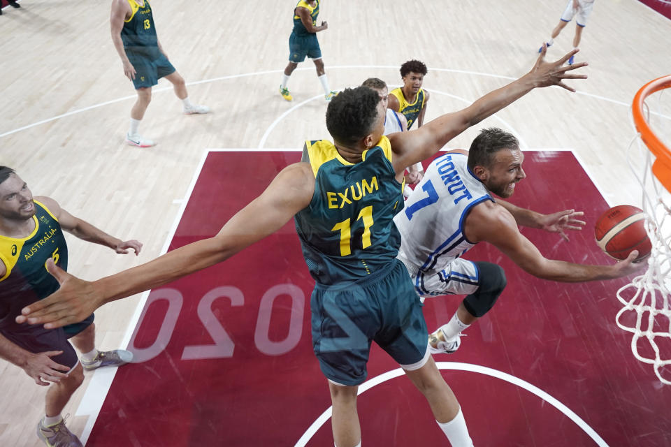 Italy's Stefano Tonut (7) drives to the basket past Australia's Dante Exum (11) during a men's basketball preliminary round game at the 2020 Summer Olympics, Wednesday, July 28, 2021, in Saitama, Japan. (Charlie Neibergall/Pool Photo via AP)