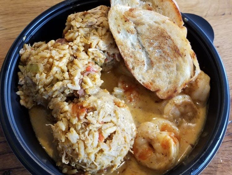 Shrimp bowl with bread and rice.