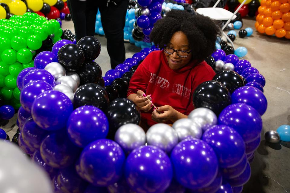 Indianapolis balloon artist Rye Von works in a bumper car on Wednesday, April 24, 2024, ahead of the Big Balloon Build charity event this weekend at the Northern Indiana Event Center in Elkhart County.