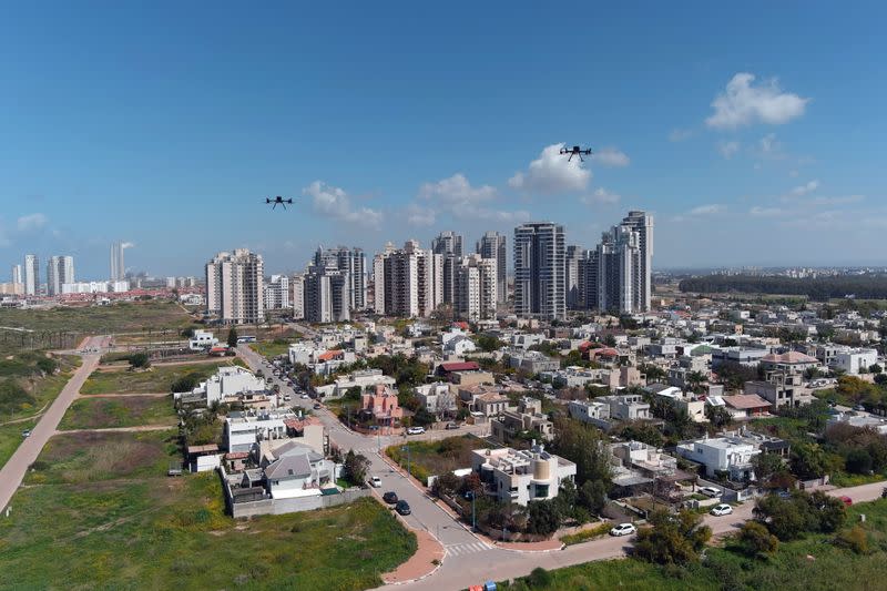 Delivery drones are seen midair during a demonstration whereby drones from various companies flew in a joint airspace and were managed by an autonomous control system in Haifa, as Hadera is seen in the background