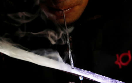 A drug user inhales "Shabu", or methamphetamine, at a drug den in Manila, Philippines February 13, 2017. REUTERS/Erik De Castro