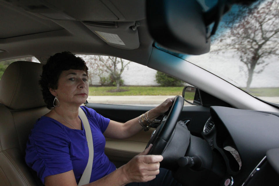 In this Thursday, Oct. 4, 2012 photo retiree Jamie Reilly, of North Providence, R.I., drives her car in North Attleboro, Mass. Reilly left her job as a secretary at age 50, thinking her 30 years of state employment would mean good benefits during her later years. But now she said she may be forced to re-enter the workforce at age 55 because the state has put off pension increases. (AP Photo/Steven Senne)