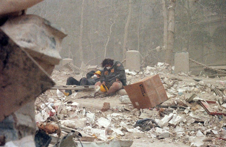 An exhausted firefighter collapses on the ground. (Caters)