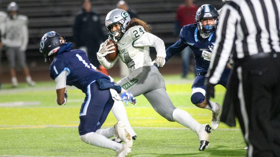 Granite Bay’s Isaiah Ene runs the ball during the CIF Sac-Joaquin Section Division 2 playoff game at Downey High School in Modesto, Calif., Friday, Nov.11, 2022.