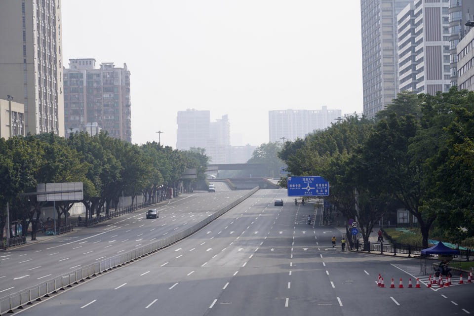 Few cars are seen on the empty street in the recently locked down Haizhu district in Guangzhou in southern China's Guangdong province Friday, Nov. 11, 2022. As the country reported 10,729 new COVID cases on Friday, more than 5 million people were under lockdown in the southern manufacturing hub Guangzhou and the western megacity Chongqing. (AP Photo)