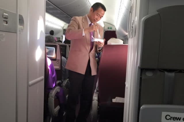 Thai Airways flight attendant praised for helping elderly man eat