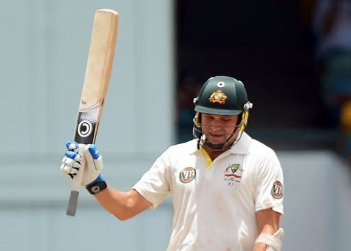 Australian cricketer Ryan Harris rises his bat after completing his half century (50 runs) during the fourth day of the first-of-three Test matches between Australia and West Indies at the Kensington Oval stadium in Bridgetown