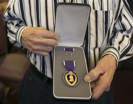 World War II veteran Richard "Dick" Faulkner displays his Purple Heart medal after being honored in Auburn, New York March 8, 2014. REUTERS/Mike Bradley