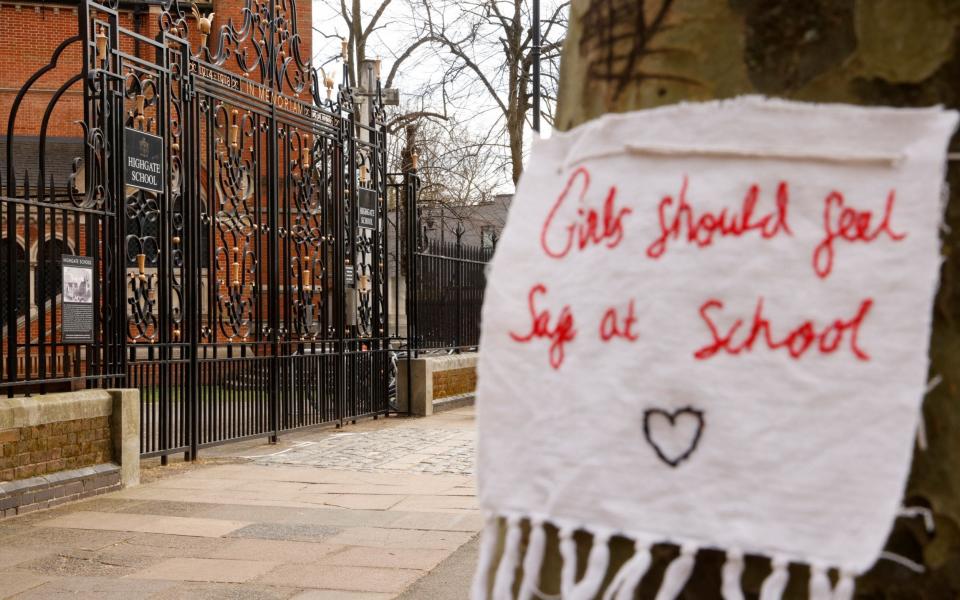 A sign attached to a tree outside the entrance to Highgate School, in London - John Sibley/Reuters