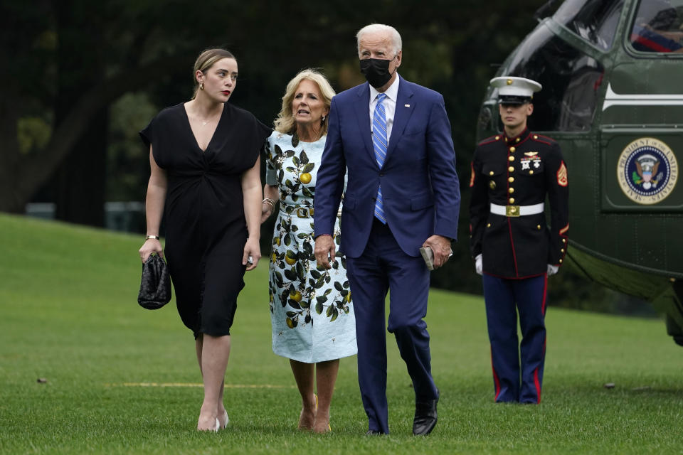 First lady Jill Biden, President Joe Biden and their granddaughter Naomi Biden walk together on the White House’s South Lawn. - Credit: AP