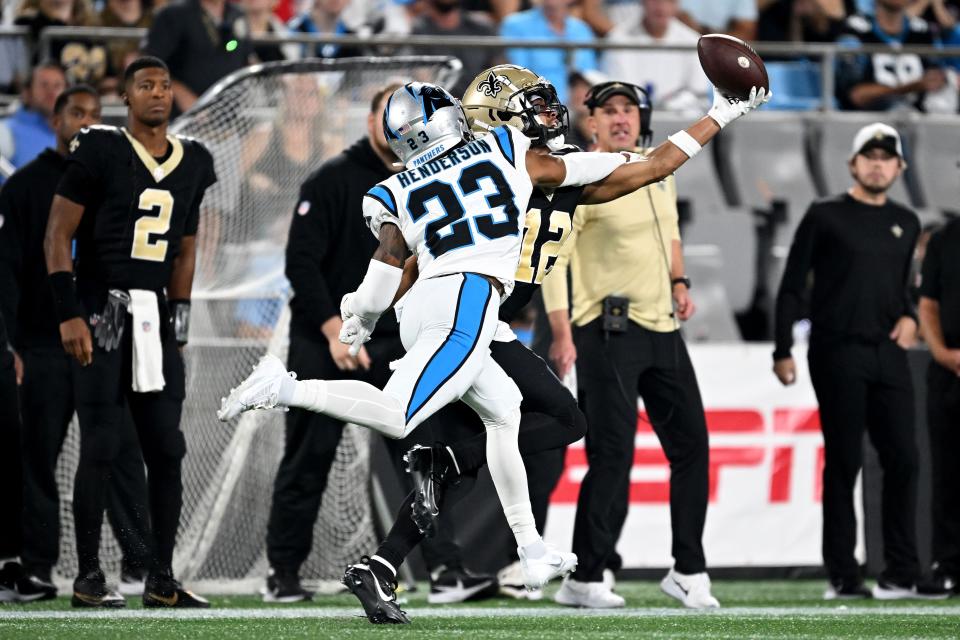 CHARLOTTE, NORTH CAROLINA - SEPTEMBER 18: Chris Olave #12 of the New Orleans Saints bobbles and catches a 42 yard pass against CJ Henderson #23 of the Carolina Panthers during the third quarter in the game at Bank of America Stadium on September 18, 2023 in Charlotte, North Carolina. (Photo by Grant Halverson/Getty Images)